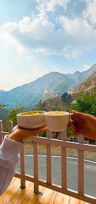 Scenic mountain view hands with coffee